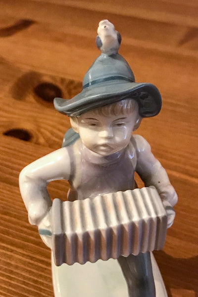 Metzler and Ortloff German vintage figurine of a young boy playing an accordion - TheReedLounge.com