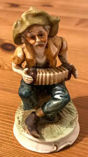 Pottery figurine of an Elderly gentleman playing concertina outside. - TheReedLounge.com