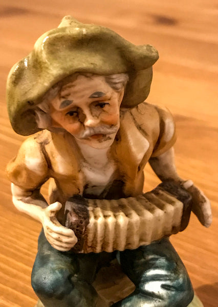 Pottery figurine of an Elderly gentleman playing concertina outside. - TheReedLounge.com