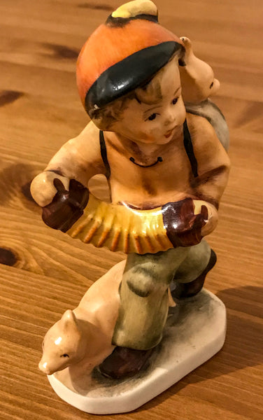 Porcelain figurine of a boy playing concertina - TheReedLounge.com